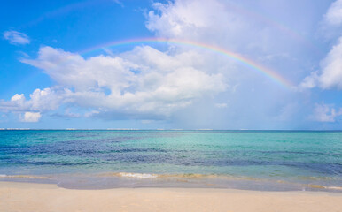 Rainbow with lots of clouds and turquoise sea water on north beach of isla mujeres cancun, Mexico. Mexican Caribbean beaches