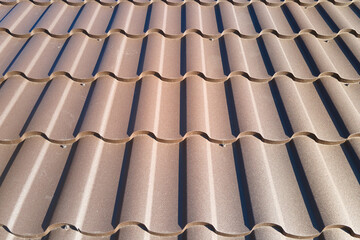 Closeup of house roof top covered with metallic shingles