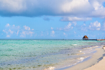 straw harbor on mexican caribbean beaches.turquoise blue beach of isla mujeres with a dramatic sky with clouds.