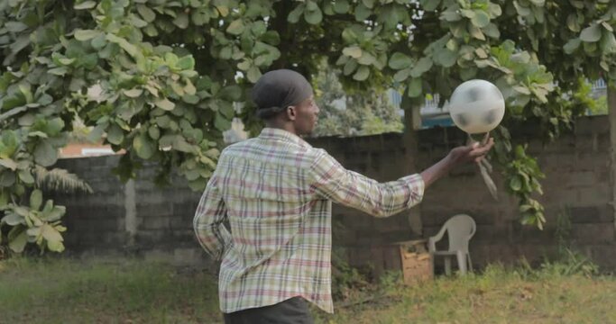 young Nigerian man spinning a ball
