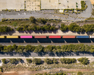 A cargo train carrying shipping containers passes through South Fremantle Industrial area © Terence
