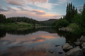Sunset reflected on forest lake