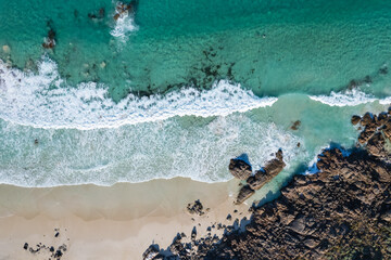 An aerial shot of two surfers waiting for a wave at Torpedo Rocks in Yallingup, WA