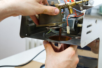 The master repairs the coffee machine. household appliances repair at home