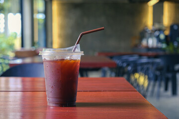 Black ice coffee or Americano coffee on wood table.