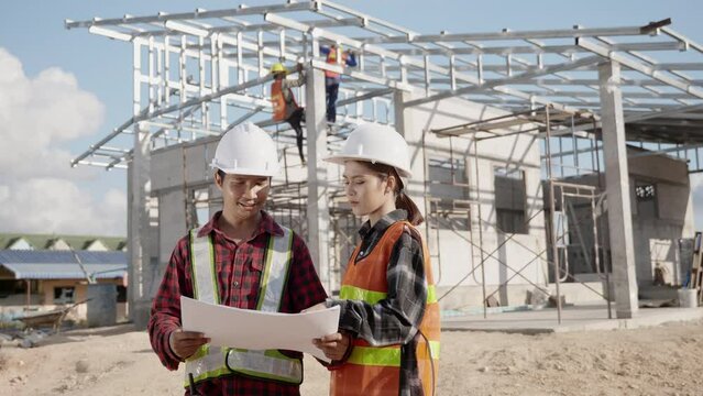 Two architect and client discussing help create plan with blueprint home building at construction site