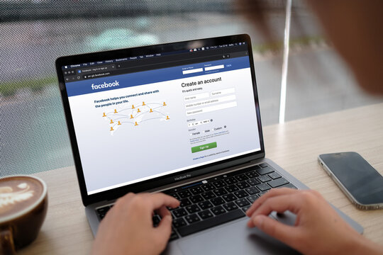 Bangkok. Thailand. JAN 31,2022 :Facebook social media app logo on log-in, sign-up registration page on  app screen on laptop smart devices in business person's hand at work.