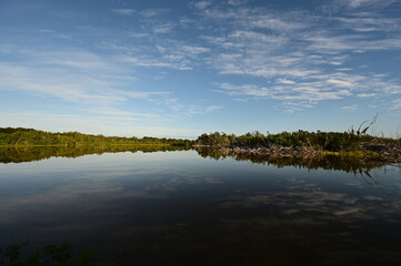Fototapeta na wymiar Morning clouds over Eco Pond in Everglades National Park, Florida reflected in pond's tranquil water.
