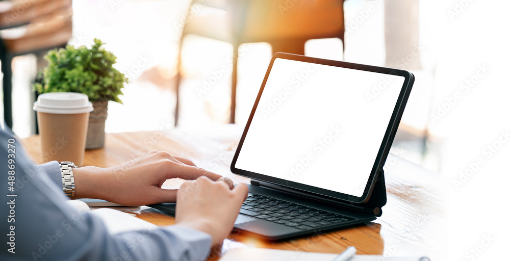 Poster cropped shot of businessperson using and reading informations on mock-up tablet.