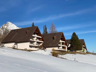 Traditional Swiss architecture and wooden alpine houses in the winter ambience of fresh white snow cover, Alt St. Johann - Obertoggenburg, Switzerland (Schweiz)