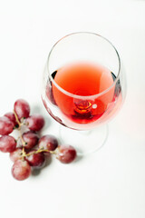 Glass with red wine beautiful still life. Wineglass and grape
