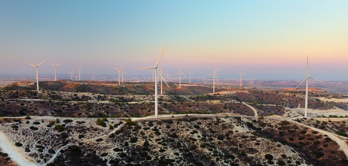 Group of wind power station for renewable electric energy production. Windmills on the sunset. High...