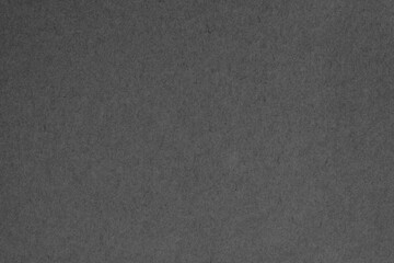 Black grey cardboard sheet texture background, pattern of kraft paper with vintage style.