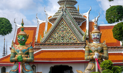 Statues at the landmark Wat Arun Buddhist Temple in Bangkok Thailand