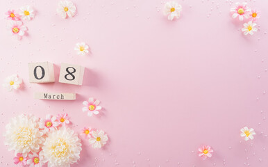 Happy Women's Day decoration concept made from flower and wooden calendar on pink pastel background.