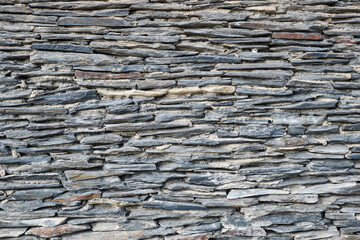 Background from a wall made of old slate slabs