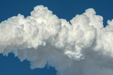 Powerful industrial factory chimney is smoking and polluting the environment with carbon dioxide