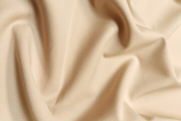 Golden crumpled or wavy fabric texture background. Abstract linen cloth soft waves. Silk atlas or...