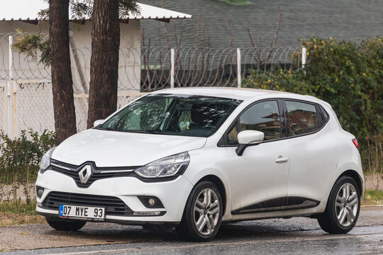 Side, Turkey -February  02, 2022: white  Renault Clio  is parked  on the street on a warm day against the backdrop of a buildung,   park