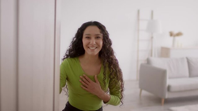 Excited Lady Opening Door And Welcoming You Standing At Home