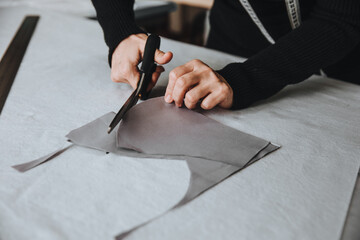 Tailor designer working of cutting piece of cloth with scissors, entrepreneur concept