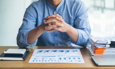 Businessman looking at graphics. Manager or auditor reading reports. Financial planning, business...