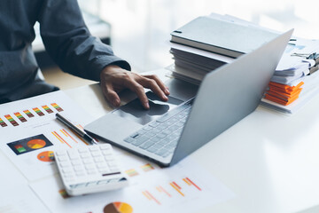 Businessman working laptop for new architectural project. Generic design notebook on the table. Blurred background, horizontal mockup.