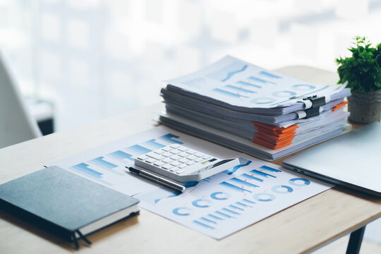 The report summarizes the results of business operations, pen, calculator on desk of investor. - Powered by Adobe