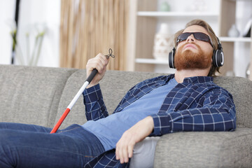 blind man sitting on sofa at home