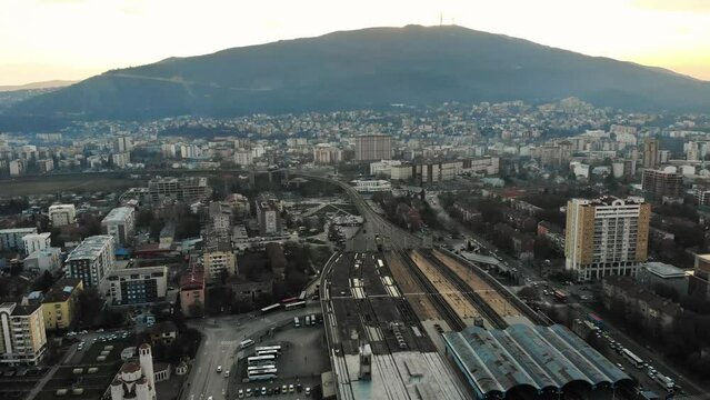 The surrounding area of the Skopje Train and Bus Station with the Vodno Mountain in the background, Aerial drone shot