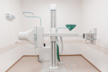 Hospital Radiology Room. X-ray department in modern hospital. Medical equipment. scan machine for fluorography. Technician adjusting an xray machine. Scanning chest, heart, lungs in modern clinic