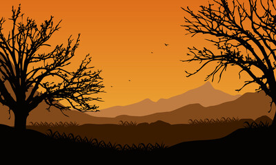 The view of the mountains with the silhouettes of large trees is stunning at dusk from the village