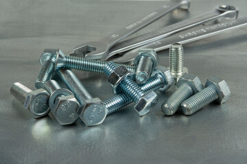 Tool for assembling threaded connections. Wrenches, nuts and bolts. Close-up on the background of a metal blank.