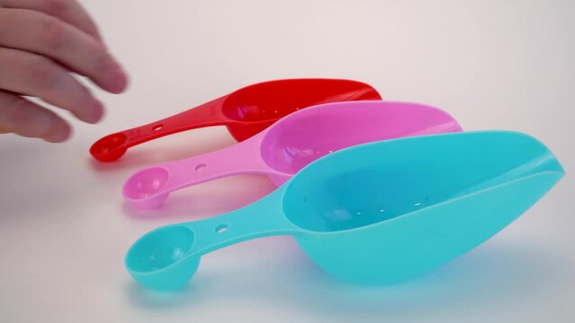 spatulas for cereals and spices on a white background. set of colored scoops for bulk products.