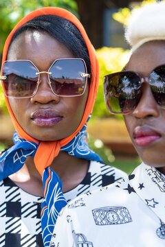 Portrait of two young African women in sunglasses
