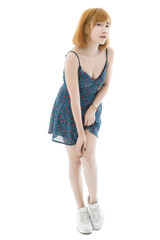Isolated cutout studio full body shot of Asian young sexy blonde short hair female fashion model in camisole dress and sneakers standing look at camera on white background