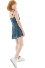 Naklejka premium Isolated cutout studio full body shot of Asian young sexy blonde short hair female fashion model in camisole dress and sneakers standing look at camera on white background