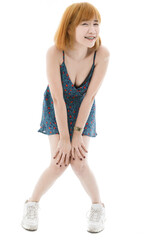 Isolated cutout studio full body shot of Asian young sexy blonde short hair female fashion model in camisole dress and sneakers standing look at camera on white background