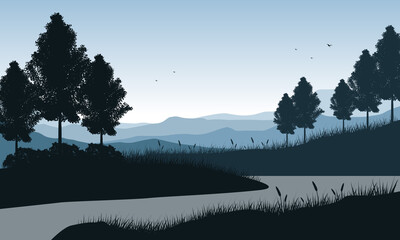 Panorama of mountains by the river in the morning with the silhouettes of pine trees around it