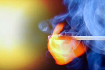 Burning match with blue smoke