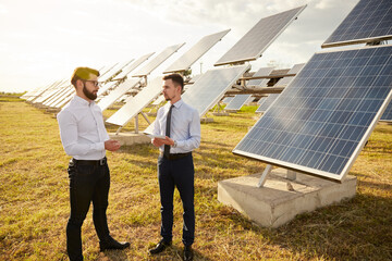 Colleagues in formal wear discussing solar power station project