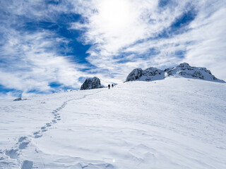 climbers stepping to the summit and wonderful winter in the mountains