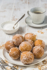 Fried curd balls with sugar on white wooden background. Concept of coffee break. Copy space.