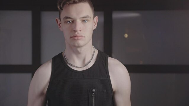Young Active Man Exercise With One-Handed Dumbbell At Home. Medium Shot