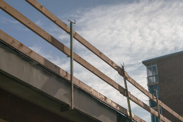 Railing for construction site, on the edge of the roof hooked to the roof cornice of the building...