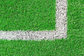 Part of football or soccer field close up, Artifical green grass with white border lines, Astroturf...