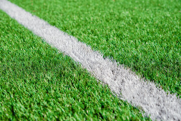Part of football or soccer field close up, Artifical green grass with white border lines, Astroturf...