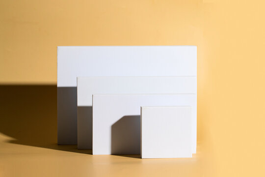 White square podiums  on beige background for  for show products.Podium scene  for show products