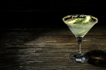 Glass of Jalapeno cocktail on rustic wooden background