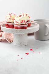 Red velvet cupcake with cream cheese frosting and red hearts sprinkles on the top. Valentine's Day...